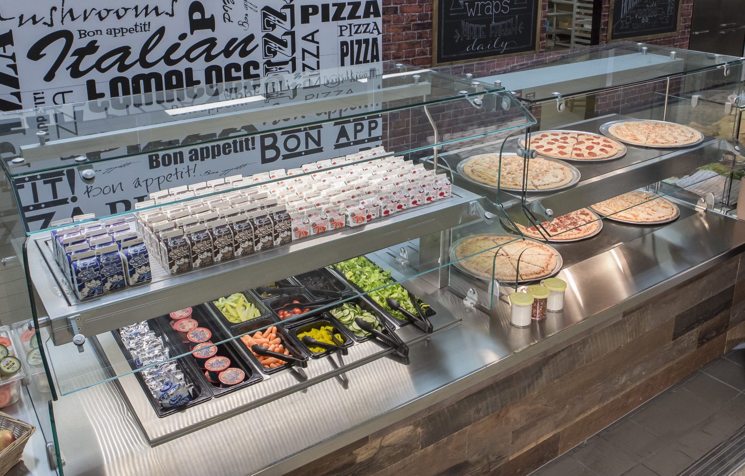 two tier glass food display serving salad and pizza