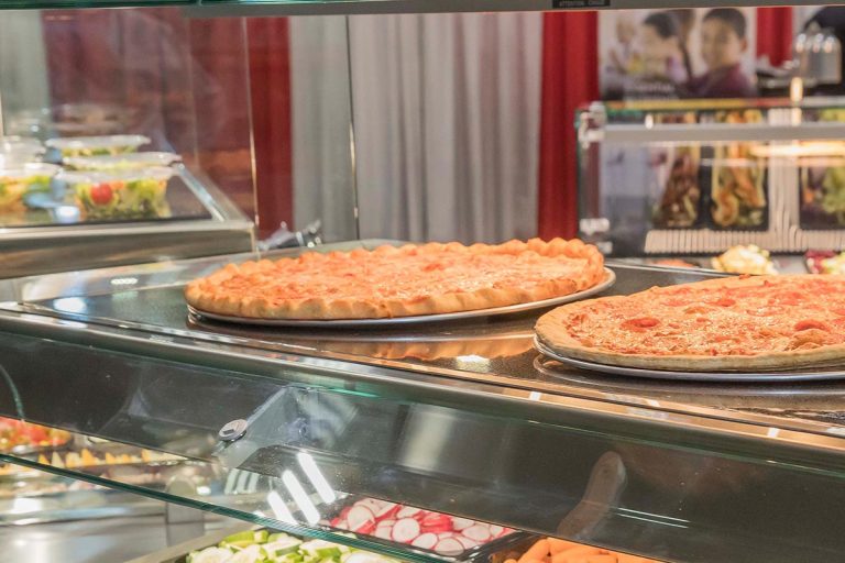 glass hot food display case serving pizza